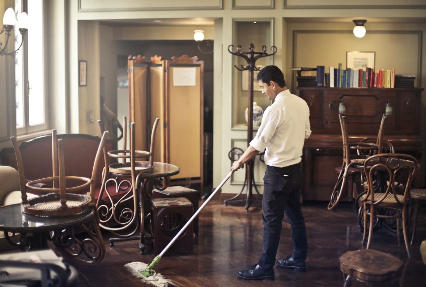 Mopping a hard floor with a professional flat mop